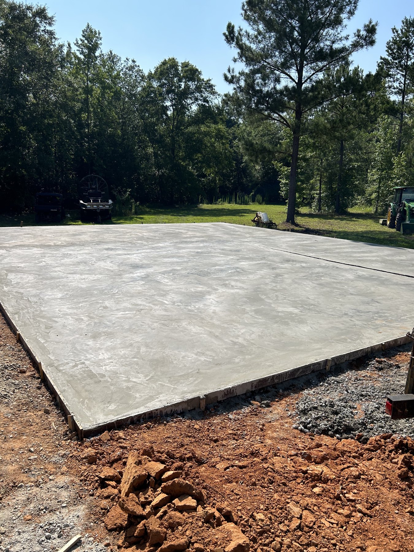 Large backyard slab driveway and pad concrete project completed by Colquitt Concrete in Georgia