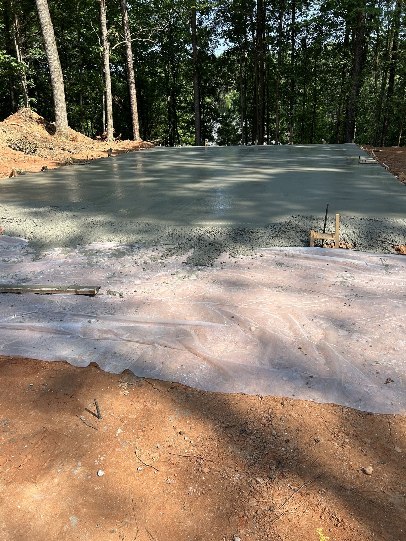 Large backyard slab after photo 3 showing finished driveway and pad concrete work by Colquitt Concrete in Georgia