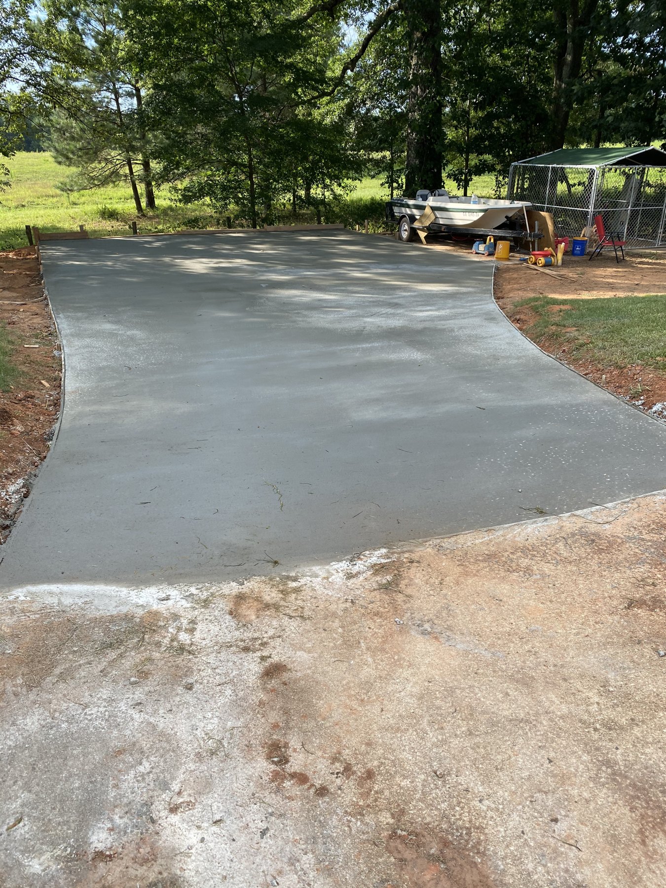 Large backyard slab after photo 4 showing finished driveway and pad concrete work by Colquitt Concrete in Georgia