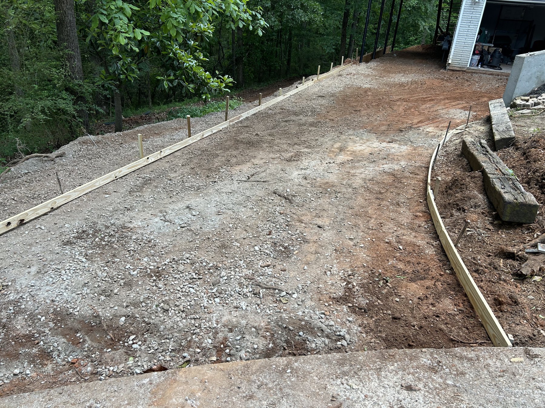 Large backyard slab before photo 1 showing driveway and pad concrete preparation by Colquitt Concrete in Georgia