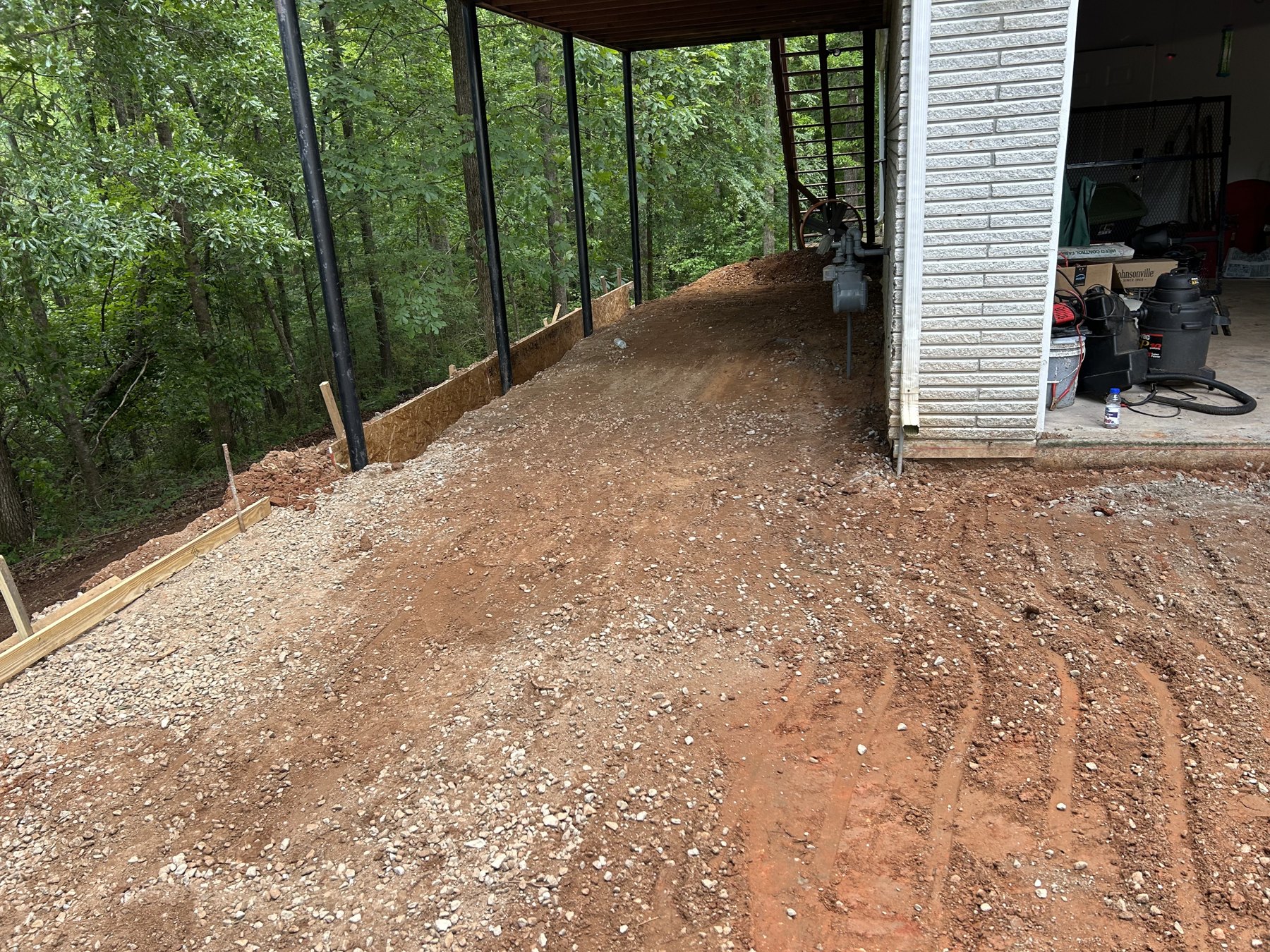 Large backyard slab before photo 2 showing driveway and pad concrete preparation by Colquitt Concrete in Georgia