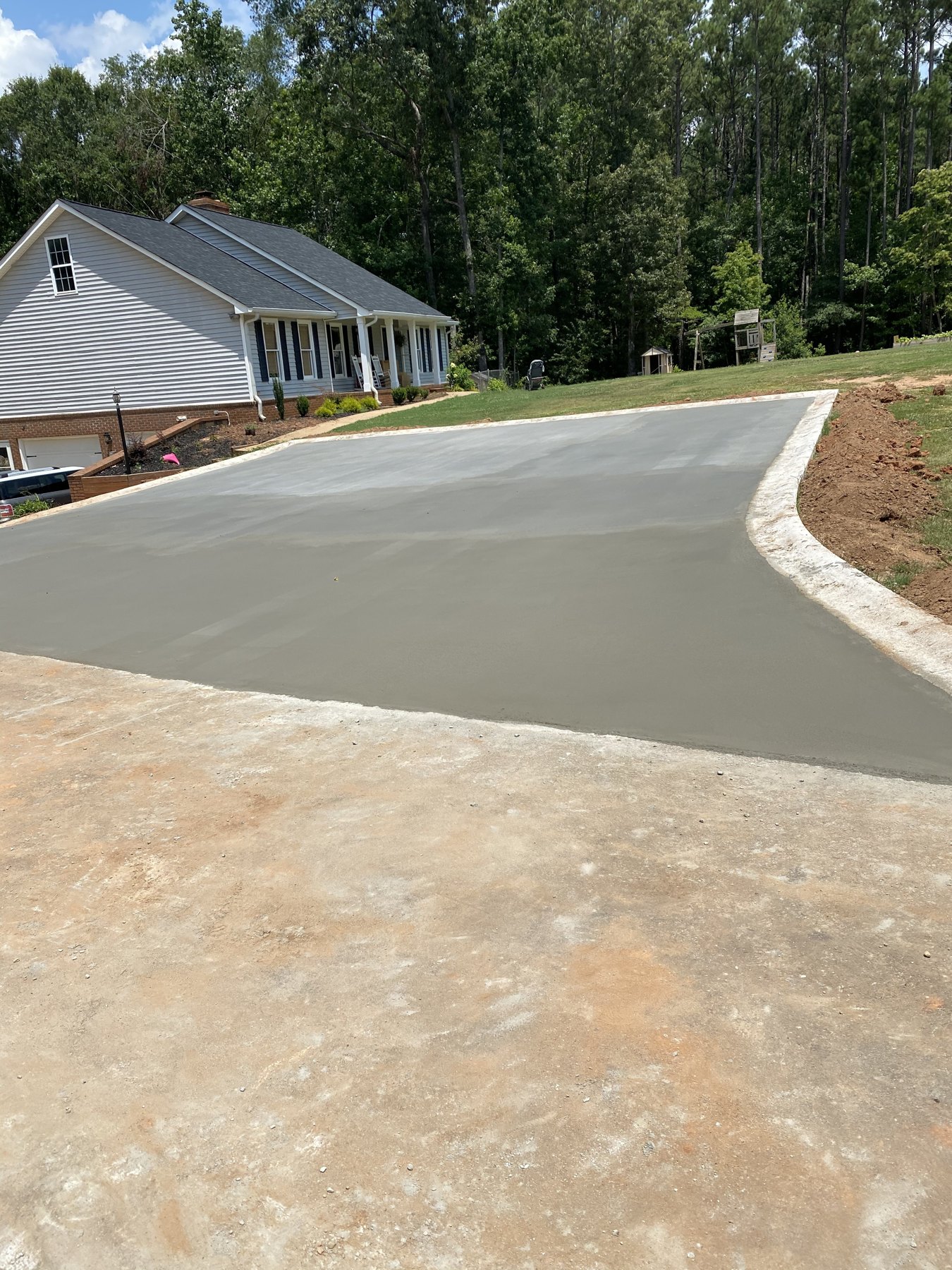 Large residential drive after photo 1 showing finished driveway concrete work by Colquitt Concrete in Georgia
