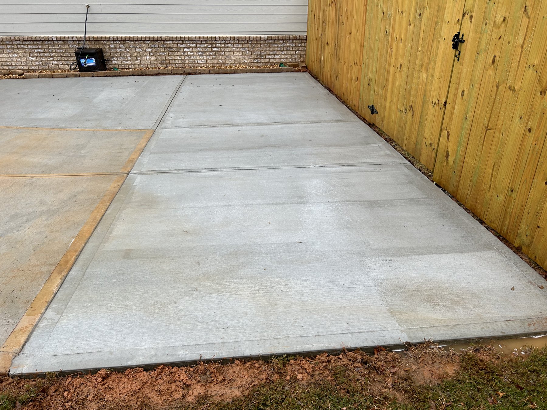 Side driveway extension after photo 2 showing finished driveway concrete work by Colquitt Concrete in Georgia