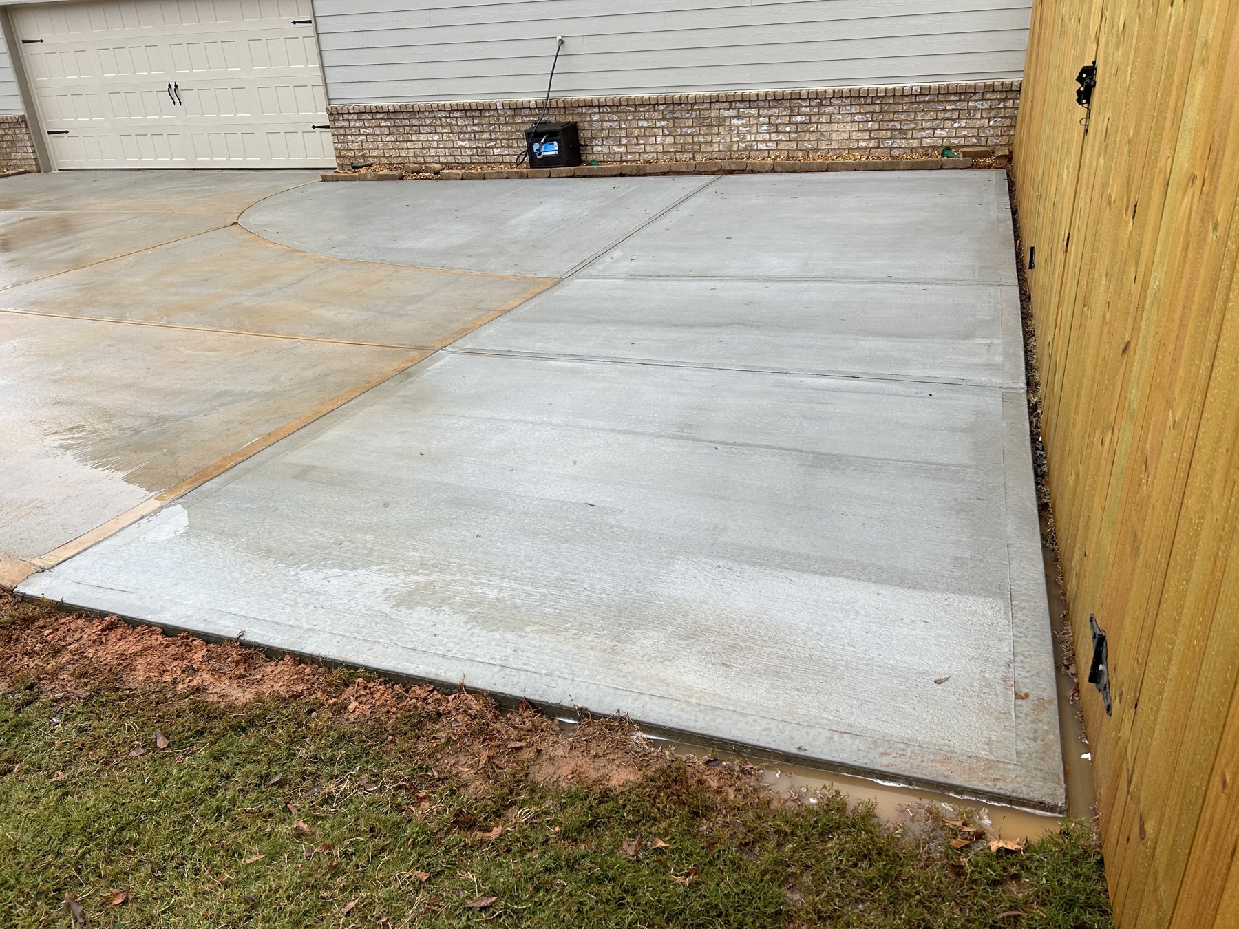 Side driveway extension after photo 3 showing finished driveway concrete work by Colquitt Concrete in Georgia